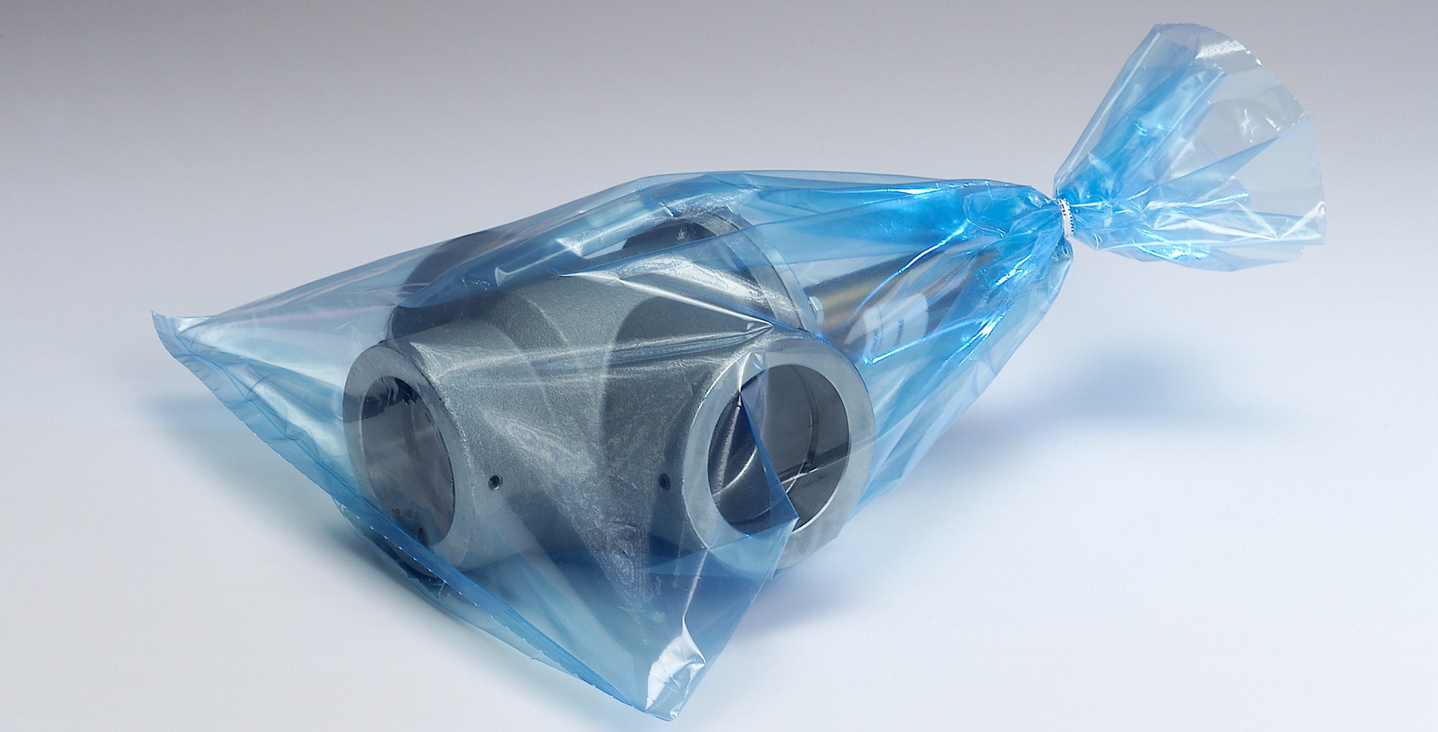 Machined steel part sealed inside a blue-tint VCI polyethylene bag