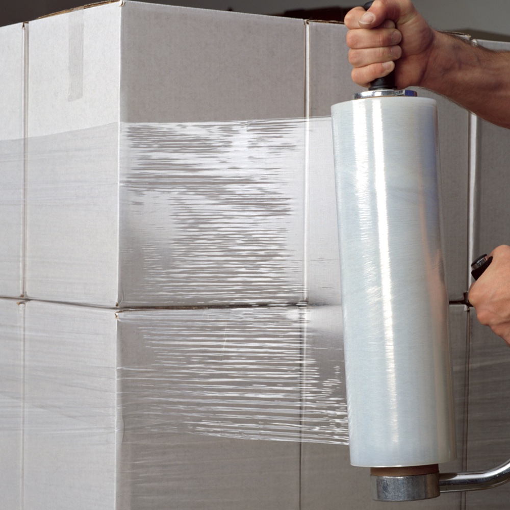 Hand stretch wrap film being applied to stacked boxes on a pallet